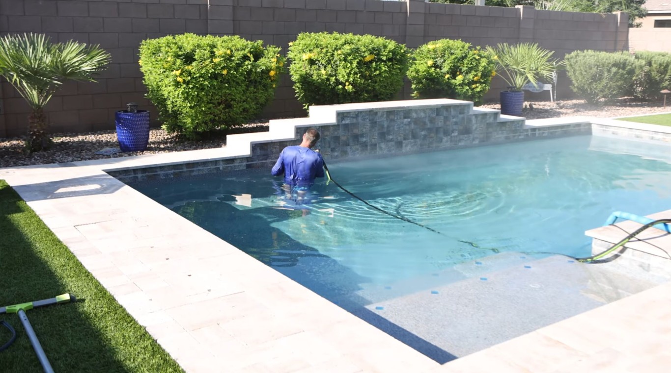 Professional pool technician performing weekly pool cleaning service in Princeton, TX